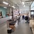 A clean, organized laboratory workspace with desks, chairs, and storage boxes.